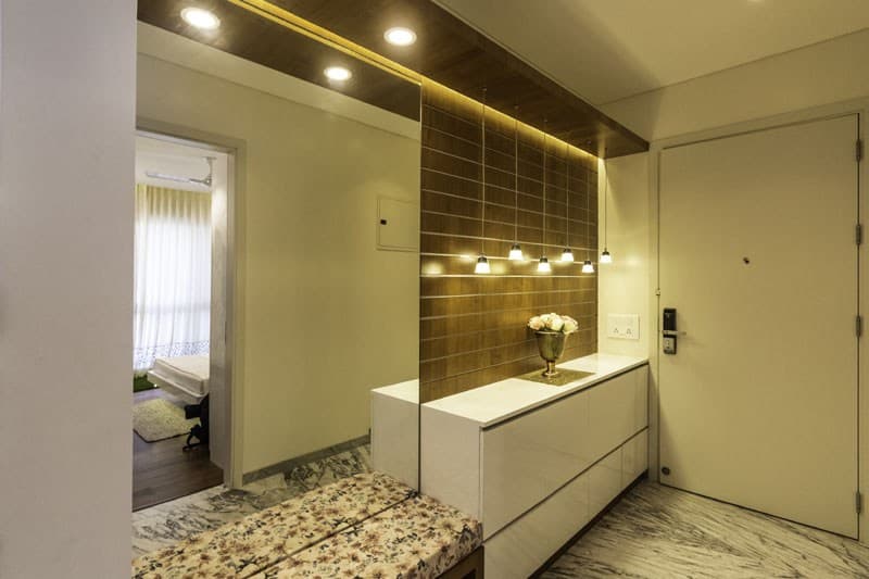 Entrance-Foyer-incorporating-Wall-Mounted-Mirror-Wooden-Wall-Panelling-highlighted-with-Grooves-continuing-in-Ceiling-with-Recessed-Hanging-Pendant-Light-1 Design Detail Banner 0