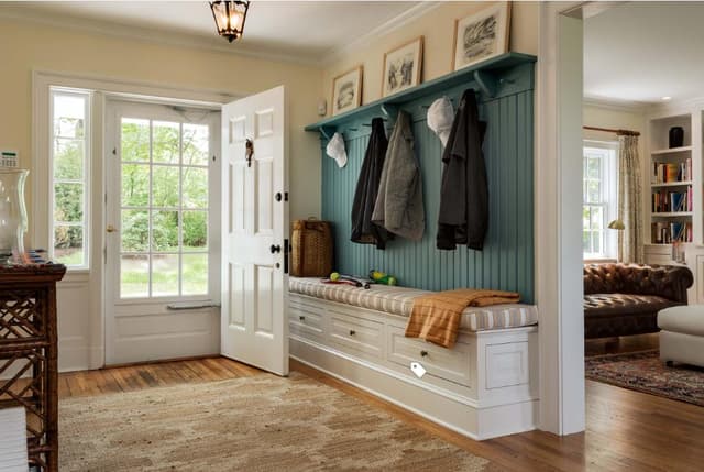 Entrance-Foyer-with-Cushioned-Wooden-Seating-having-Storage-below-Wooden-Back-Panelling-having-Wooden-Brackets-Hooks-for-Coats Swiper Content 0