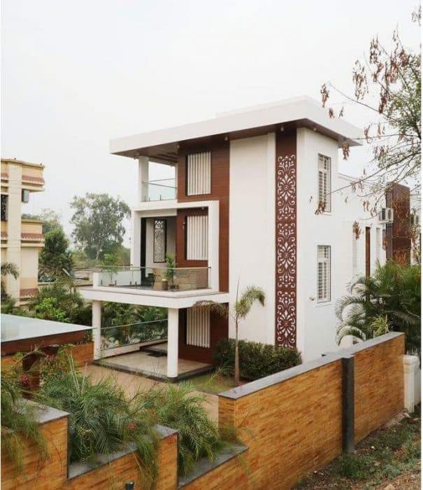 Exterior-View-of-Contemporary-Styled-White-Brown-Themed-G1-Storey-Bungalow-highlighted-with-Backlit-Jali-Wall-2 Swiper Content 1