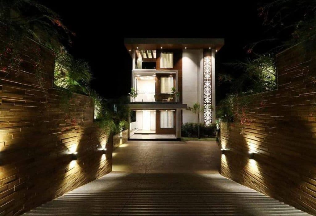 Exterior-View-of-Contemporary-Styled-White-Brown-Themed-G1-Storey-Bungalow-highlighted-with-Backlit-Jali-Wall-3 Design Detail Banner 2