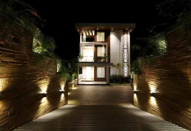 Exterior-View-of-Contemporary-Styled-White-Brown-Themed-G1-Storey-Bungalow-highlighted-with-Backlit-Jali-Wall-3 Swiper Content 2