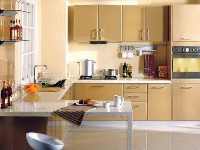 G-Shaped-Kitchen-with-a-Peninsula-contains-Beige-Coloured-Upper-Lower-Cabinets-with-SS-Handles-Tall-Unit-with-Built-in-Oven-Built-in-Stove-with-Hidden-Chimney-under-a-Cabinets G Shaped Kitchen