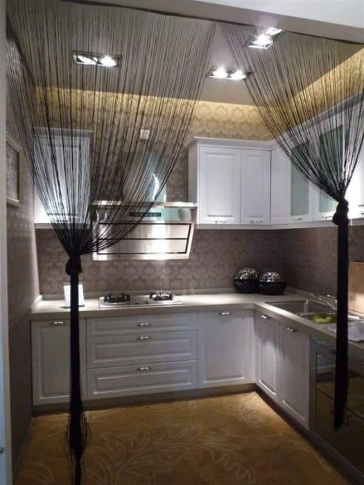 Kitchen-with-L-Shaped-Kitchen-Counter-Lower-Kitchen-Cabinets-with-Stainless-Steel-Handles-Upper-Kitchen-Cabinets-with-Glass-Wooden-Doors Swiper Content 0