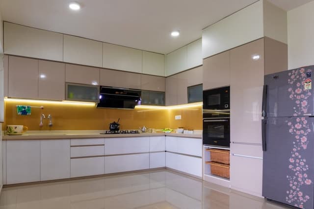 L-Shaped-Modern-Modular-Kitchen-with-a-combination-of-White-Beige-is-making-it-Simple-Elegant.-1 Swiper Content 0