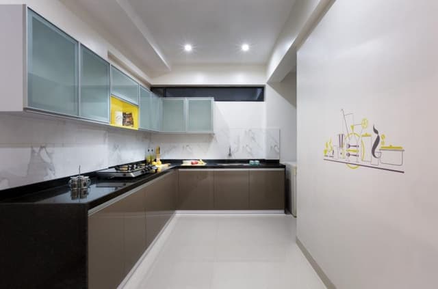 L-Shaped-Modular-Kitchen-with-Black-Granite-Countertops-Lower-Cabinets-with-Aluminum-Profile-Handles-Upper-Cabinets-with-Glass-Shutters-with-a-Highlighter-Yellow-Coloured-Open-display-Box Swiper Content 0