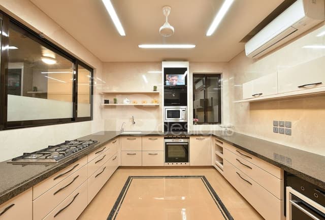 Large-U-Shaped-Kitchen-with-Granite-Countertop-Lower-and-Upper-Cabinets-with-Slender-Handles-Built-in-Stove-Under-Counter-Single-Bowl-Sink-Built-in-Oven-and-Microwave-Unit. Swiper Content 0