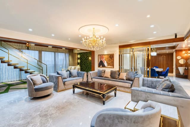 Lavish-Living-Room-comprising-Square-Armed-Sofa-Set-Rectangle-Coffee-Table-Square-End-Table-Side-Nesting-Tables-Sofa-Chairs-Recliner-Under-Canteliver-Staircase-Swing-in-front-of-Stairs-2 Swiper Content 0