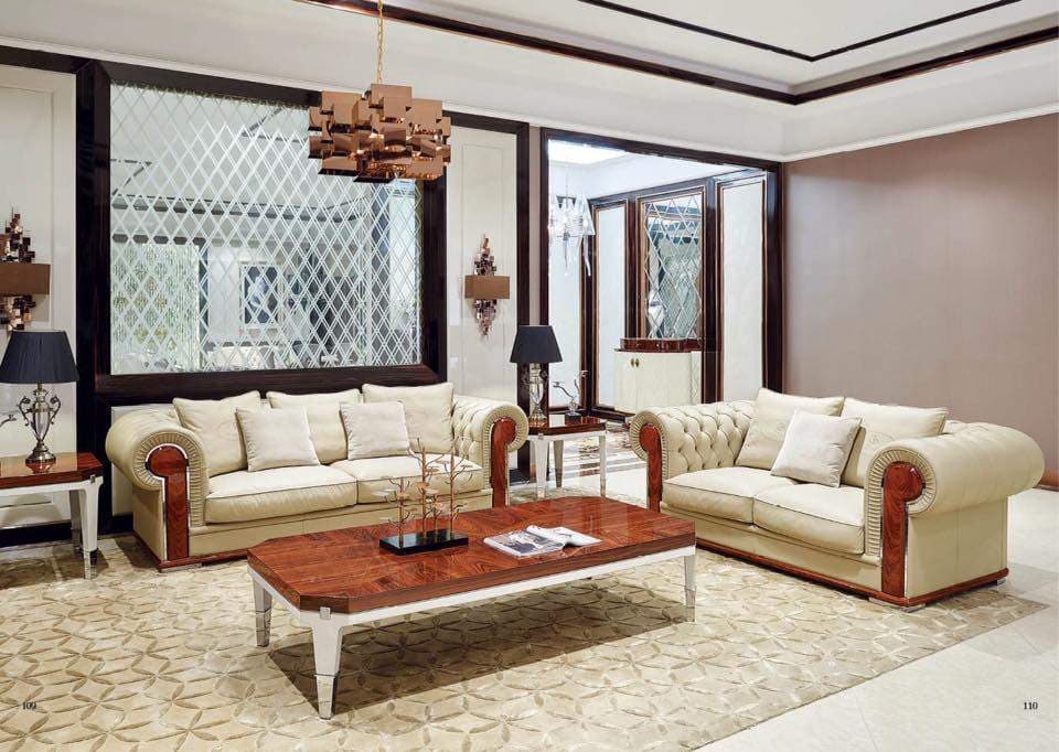 Living-Room-accommodating-Off-white-Coloured-Roll-Arm-Chesterfield-Sofa-Set-Rectangular-Wooden-Coffee-Table-Side-Tables-with-Table-Lamps-placed-on-it Design Detail Banner 0