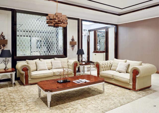 Living-Room-accommodating-Off-white-Coloured-Roll-Arm-Chesterfield-Sofa-Set-Rectangular-Wooden-Coffee-Table-Side-Tables-with-Table-Lamps-placed-on-it Swiper Content 0