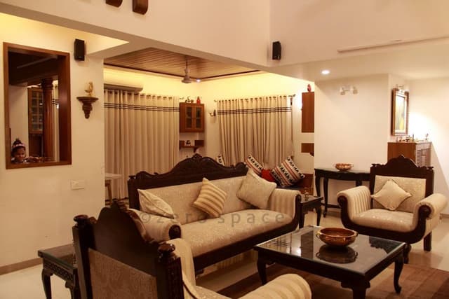 Living-Room-accommodating-Vintage-styled-Wooden-Framed-Sofa-Set-with-Cushions. Swiper Content 0