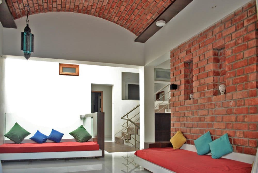 Living-Room-comprising-of-Square-Armed-Cushioned-Sofa-Exposed-Brick-Sofa-Back-Wall-with-Circular-Opening-02 Design Detail Banner 1