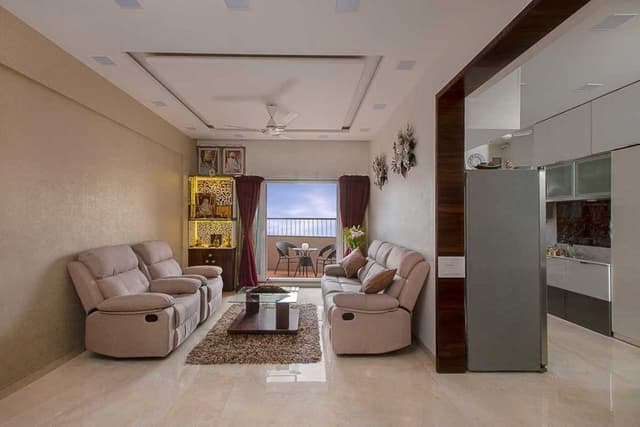 Living-Room-designed-with-Cream-Beige-Theme-incorporating-Leather-Upholstered-Recliner-Sofa-Set-Glazed-Coffee-Table-placed-on-a-Rug-Side-Table-with-a-Flower-Vase-placed-on-it-TV-unit Swiper Content 2