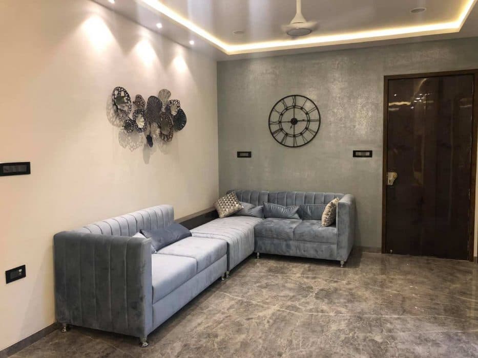 Living-Room-designed-with-Formal-Informal-rooms-accommodating-Velvet-upholstered-Grey-Coloured-Square-Armed-Modern-Sectional-Tuxedo-Style-Sofa-2 Design Detail Banner 1