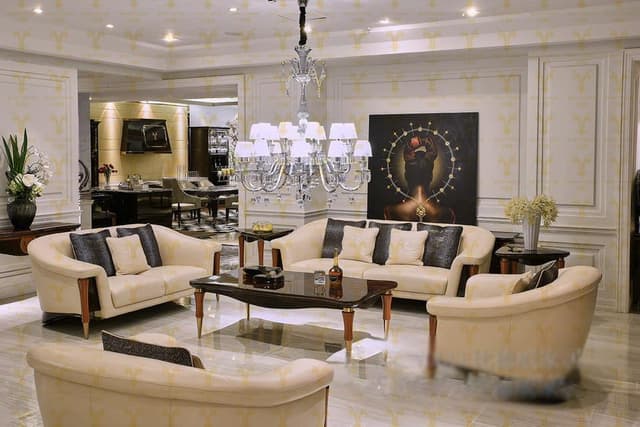 Living-Room-designed-with-Off-white-Coloured-Linen-upholstered-Sofa-Set-with-Rectangular-with-Glass-Top-Side-Tables-alongside-the-Sofa-with-Flower-Vase-on-it Swiper Content 0