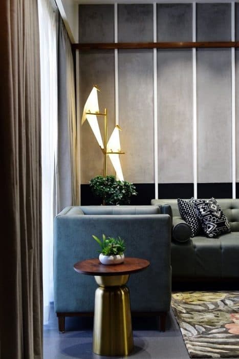 Living-Room-designed-with-Square-Armed-Leather-upholstered-Tuxedo-Button-Tufted-Sofa-Wooden-Coffee-Table-placed-on-a-Rug-3 Design Detail Banner 2