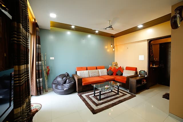 Living-Room-incorporating-L-Shaped-Sectional-Sofa-with-Orange-Colored-Sofa-Cushions Swiper Content 0