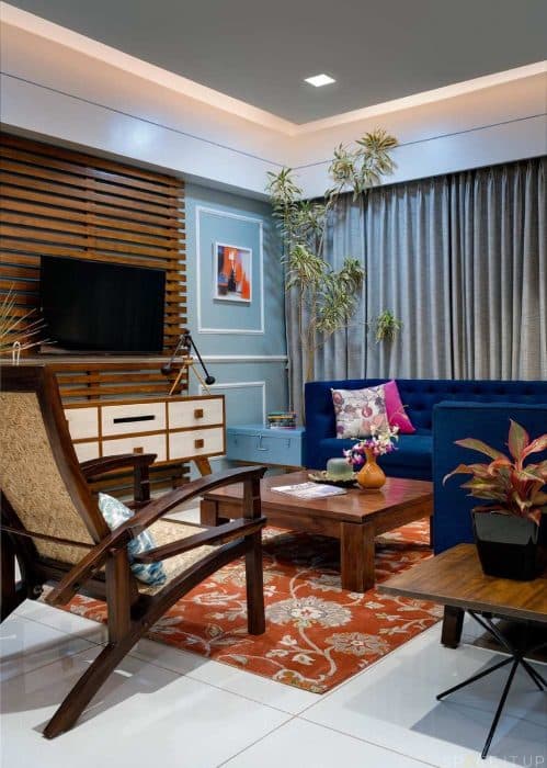 Living-Room-incorporating-Royal-Blue-Fabric-Upholstered-Tufted-L-Shaped-Sofa-Low-Heighted-Wooden-Center-Table-Wooden-Side-Table-1 Swiper Content 0