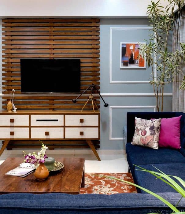 Living-Room-incorporating-Royal-Blue-Fabric-Upholstered-Tufted-L-Shaped-Sofa-Low-Heighted-Wooden-Center-Table-Wooden-Side-Table-2 Design Detail Banner 1