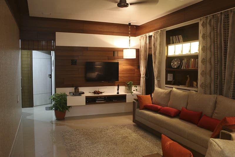 Living-Room-incorporating-Sofa-Set-with-Wooden-Base-Orange-Cushions-Wooden-Side-Table. Design Detail Banner 0