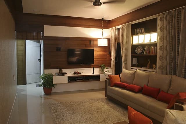 Living-Room-incorporating-Sofa-Set-with-Wooden-Base-Orange-Cushions-Wooden-Side-Table. Swiper Content 0