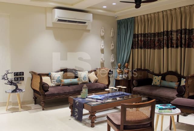 Living-Room-incorporating-Traditional-Wicker-Sofa-Sets-with-Carved-Wooden-Frames-Wooden-Side-Tables-with-Statues-Traditional-Wooden-Coffee-Table Swiper Content 0