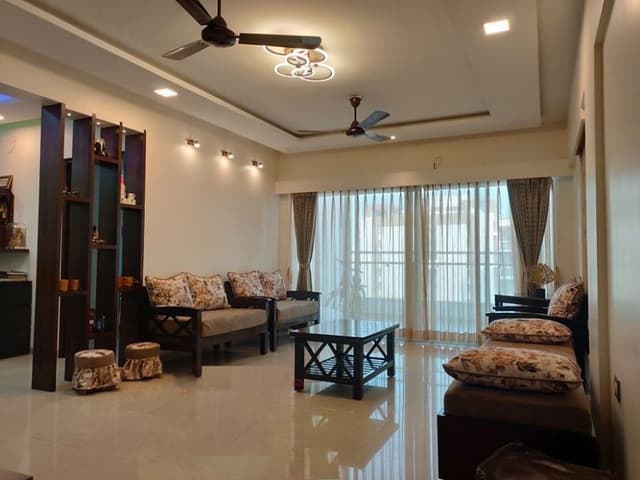 Living-Room-incorporating-Traditional-Wooden-Sofa-Set-with-Printed-Cushions-Wooden-Indian-Seating-Traditional-Wooden-Center-Table-with-Shelf.-1 Swiper Content 0