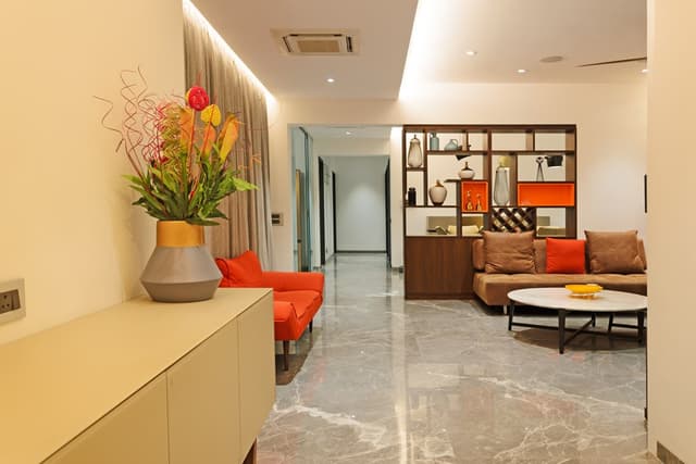 Living-Room-incorporating-Upholstered-Armless-Sofas-with-Sofa-Cushions-Circular-Center-Table-Circular-Side-Tables-Wooden-Partition-with-Open-Shelves-1 Swiper Content 0