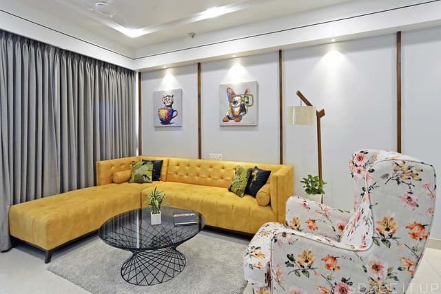 Living-Room-incorporating-Yellow-Coloured-Square-Armed-L-Shaped-Sectional-Sofa-with-Left-Facing-Chaise-Floral-Fabric-Upholstered-Wing-Chair-with-High-Back-1 Swiper Content 0