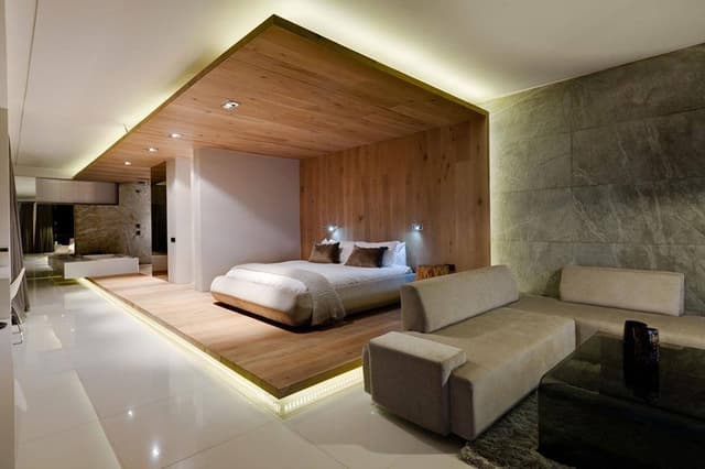 Luxurious-Contemporary-Styled-Master-Bedroom-in-an-Open-Concept-Studio-Room-accommodating-Wooden-Bed-Side-Tables-Sofa-Set Swiper Content 0