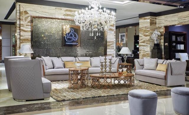 Luxurious-Living-Room-designed-with-Leather-upholstered-Grey-coloured-Sofa-Set-Round-Back-Sofa-Chairs-Round-Ottomans Swiper Content 0