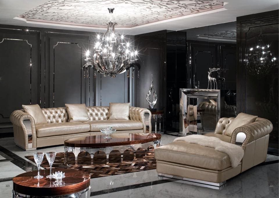 Luxurious-Living-Room-with-a-Chesterfield-Sofa-Chaise-Lounger.-The-Room-includes-an-Oval-shaped-Center-Table-with-Wooden-top-Arched-Shaped-SS-Legs-Side-Tables-with-Decor-Pieces Design Detail Banner 0