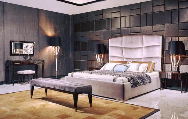 Luxurious-Modern-Bedroom-designed-with-Cushioned-Bed-High-Back-Headboard-Wooden-Side-Tables-placed-on-a-Table-Lamp-Bed-end-Bench-placed-on-a-Rug Swiper Content 0