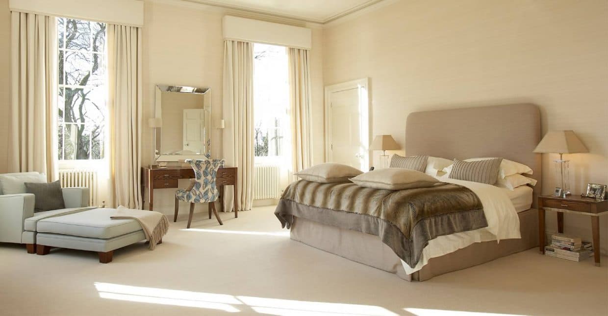 Master-Bedroom-incorporating-Beige-Shaded-Upholstered-Double-Bed-High-Upholstered-Headboard-Wooden-Side-Table-with-Drawer-Table-Lamp-above-Wooden-Dressing-Table-with-Table-Lamps. Design Detail Banner 0