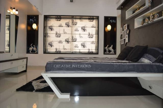 Minimalist-Bedroom-designed-with-Wooden-Bed-Side-Table-Dressing-Unit-with-Wall-Lights-above Swiper Content 0