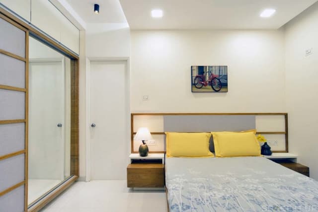 Minimalist-Bedroom-designed-with-Wooden-Bed-Side-Tables-with-Table-Lamps-placed-on-it-Wall-Painting-on-Bed-Backwall Swiper Content 0