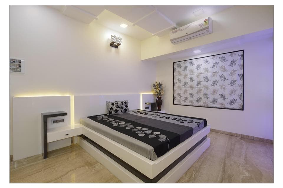 Minimalist-Bedroom-with-Wooden-Double-Bed-with-Storage-below-Wall-Mounted-Side-Tables-Wooden-Headboard-highlighted-with-Cove-Lights. Design Detail Banner 0