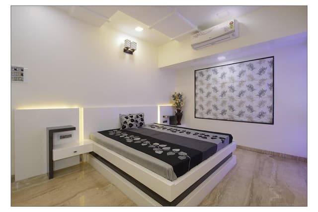 Minimalist-Bedroom-with-Wooden-Double-Bed-with-Storage-below-Wall-Mounted-Side-Tables-Wooden-Headboard-highlighted-with-Cove-Lights. Swiper Content 0