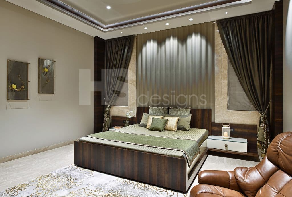 Minimalist-Restful-Bedroom-designed-with-Wooden-Bed-Wall-Mounted-Side-Tables-Corrugated-Metal-Bed-Backdrop-on-Wall-Leather-Upholstered-Recliner-Sofa-Chair-Curtains-POP-False-Ceiling. Design Detail Banner 0