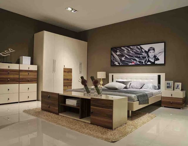 Modern-Bedroom-designed-in-a-Neutral-Colour-Scheme-with-a-Wooden-Bed-Tufted-Headboard-Side-Table-with-Drawers-for-holding-Lamps-Framed-Pictures Swiper Content 0