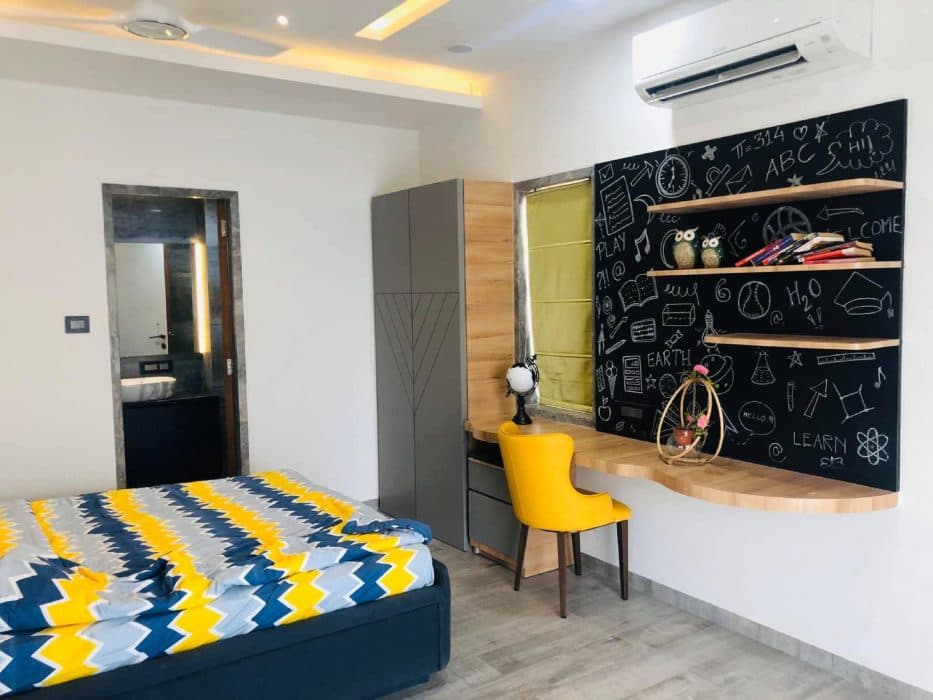 Modern-Bedroom-designed-with-a-Bright-Accent-Wall-with-Yellow-Blue-Colour-Geometric-Wallpaper-1-1 Design Detail Banner 0