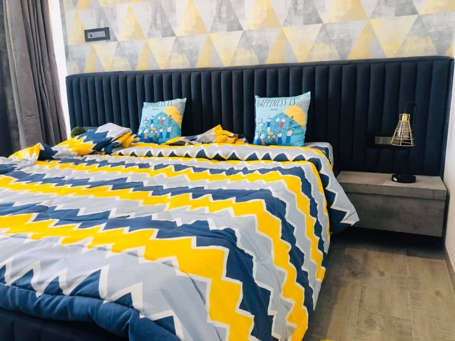 Modern-Bedroom-designed-with-a-Bright-Accent-Wall-with-Yellow-Blue-Colour-Geometric-Wallpaper-4 Design Detail Banner 3