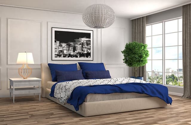 Modern-Bedroom-incorporating-Wooden-Bed-Cushions-Side-Table-with-Table-Lamp-placed-on-it Swiper Content 0