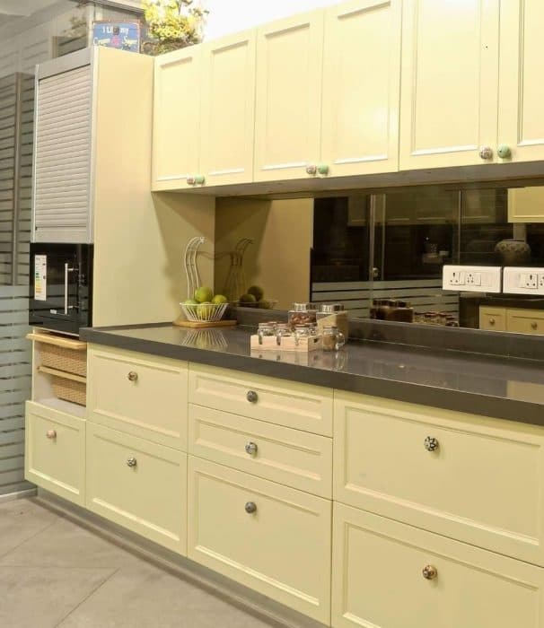 Modern-Large-Parallel-Kitchen-with-a-Glass-Portion-separating-Wash-Area.-A-Kitchen-Starts-with-a-Wooden-Storage-Unit-on-Wheels-that-highlights-a-Kind-Texts-on-Drawers-4 Swiper Content 3