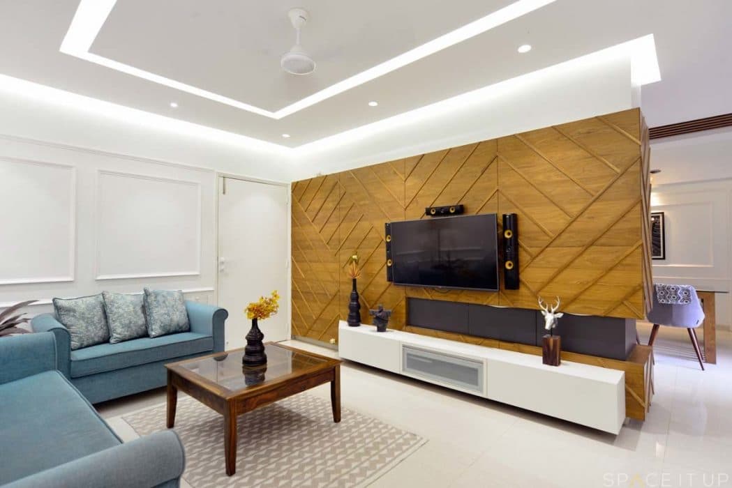 Modern-Living-Room-designed-with-Blue-Coloured-Linen-upholstered-Round-Armed-Sofa-Set-Wooden-Square-Glass-Top-2 Design Detail Banner 0