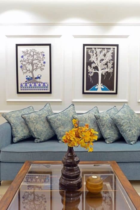 Modern-Living-Room-designed-with-Blue-Coloured-Roll-Arm-Sofa-Set-Wooden-Glass-Top-Coffee-Table-placed-on-a-Rug-Corner-Side-Table-with-Table-Lamp-Wall-mounted-T.V.-Unit-4 Design Detail Banner 3