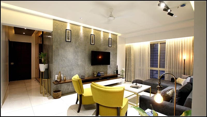 Modern-Living-Room-with-Teal-Blue-Coloured-Feature-Wall-with-Framed-Wall-Arts-highlighted-with-Track-Focus-lights-Yellow-Accents-Armchairs-1 Modern Living Room