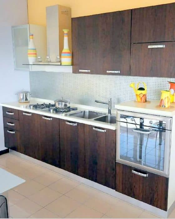 One-Wall-Kitchen-with-Solid-White-Kitchen-Countertop-Built-in-Stove-with-Chimney Design Detail Banner 0