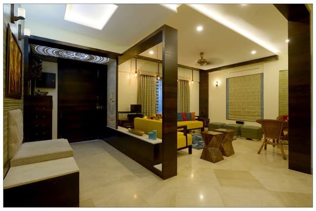Open-Concept-Foyer-Living-Room-incorporates-Foyer-with-Wooden-Door-Floor-Mounted-Wooden-Chest-of-Drawers-Backlit-False-Ceiling-continuing-in-Wall. Swiper Content 0