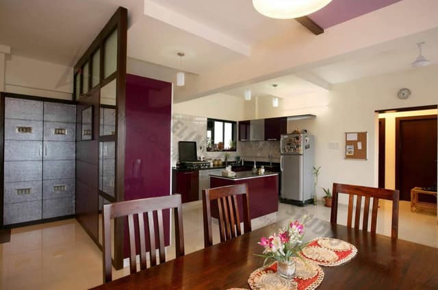 Open-Concept-Kitchen-Dining-Room-comprises-Kitchen-Counter-with-Black-Granite-Kitchen-Countertop-White-Purple-Lower-Kitchen-Cabinets-with-Stainless-Steel-Handles Swiper Content 1