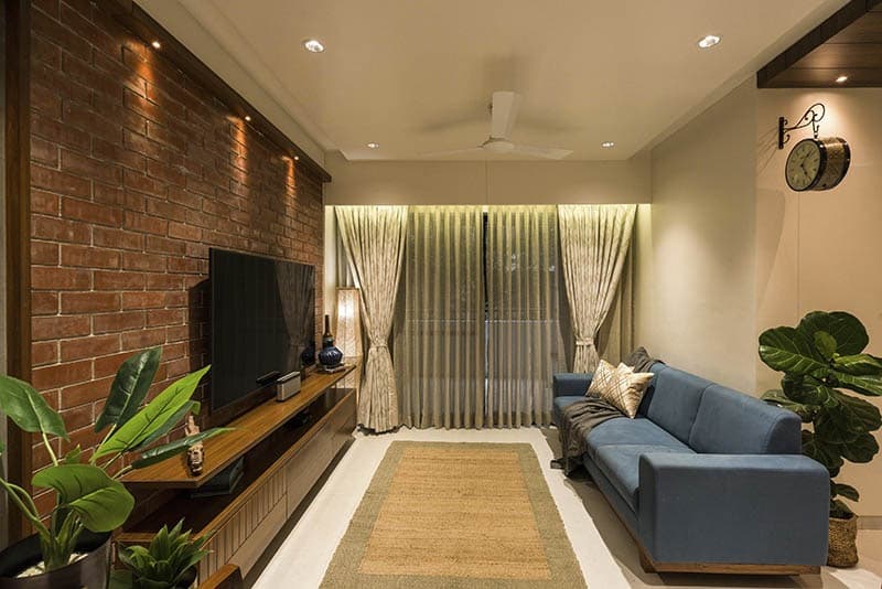 Open-Concept-Living-Dining-Room-comprises-of-Blue-Shaded-Square-Armed-Upholstered-Linear-Sofa-on-Wooden-Base. Design Detail Banner 0